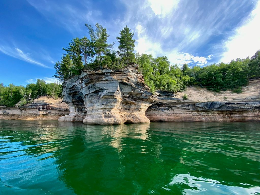 green trees beside river under blue sky during daytime, lake michigan