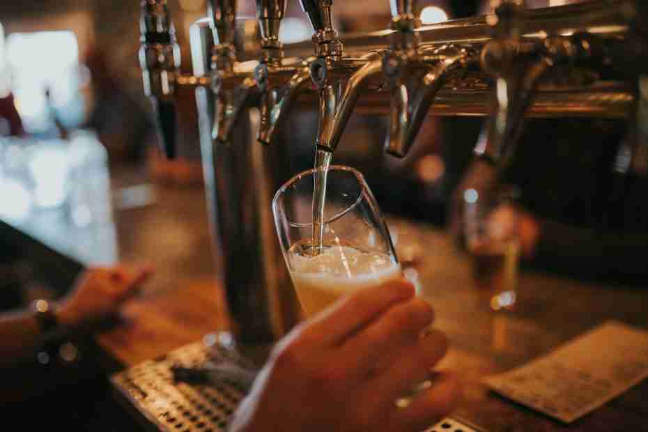 person filling beer on glass, irish pub, door county, kitty oreilly